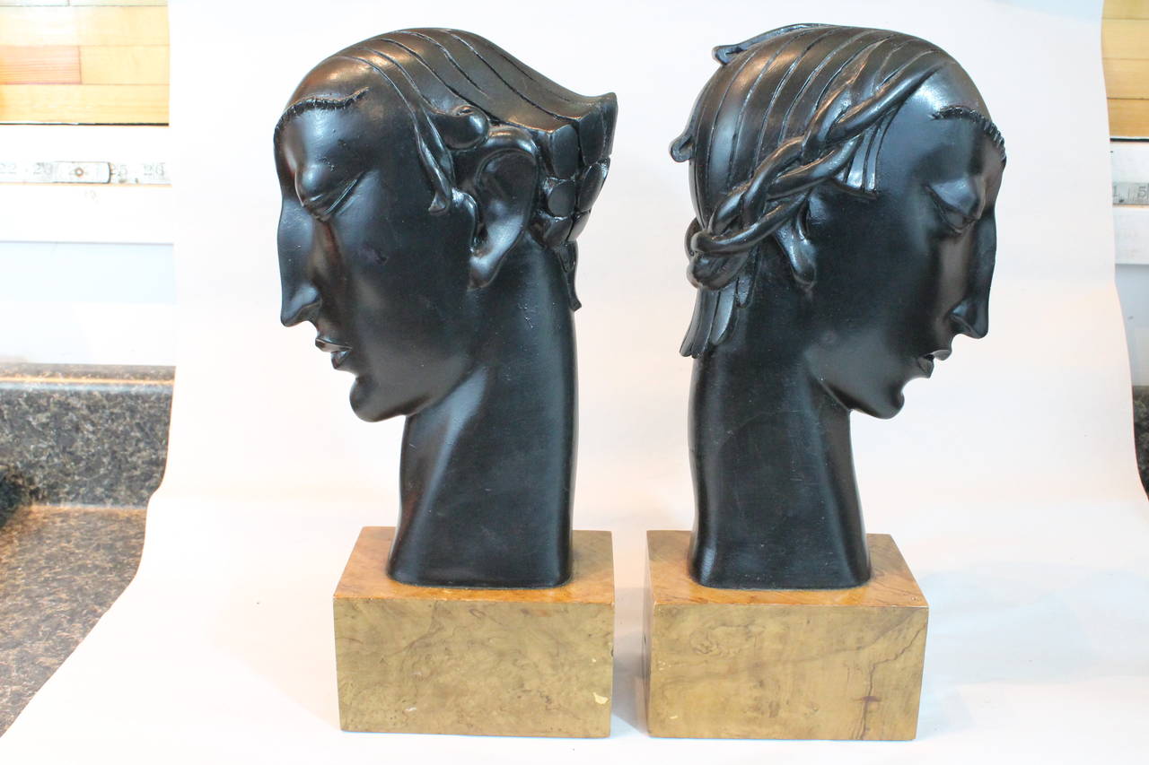 Striking pair of carved and ebonized Art Deco head form bookends.
Very graceful profiles on these very adeptly carved heads each with a different hair style, on wooden plinths.