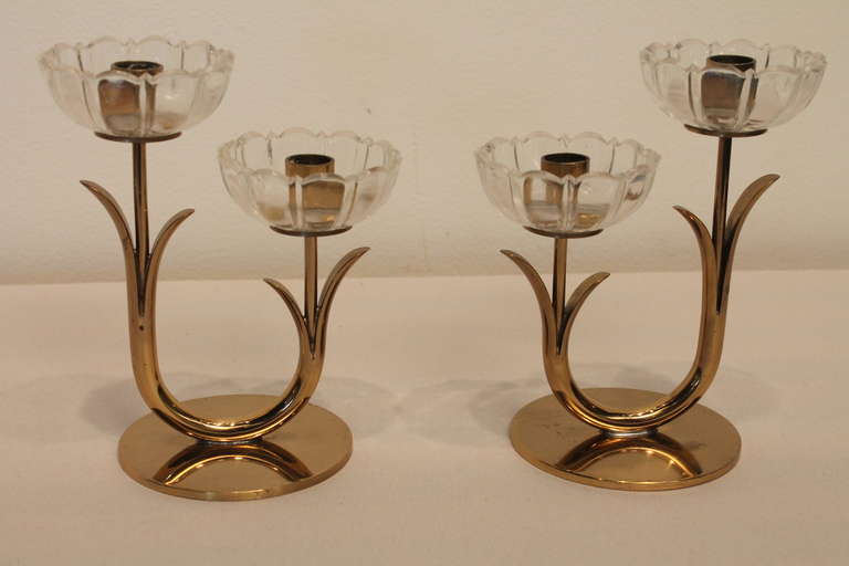 Fantastic floral motif polished brass candlesticks with glass petal form cuffs designed by Gunnar Ander for Ysted - Metall.
Incised maker's mark.
