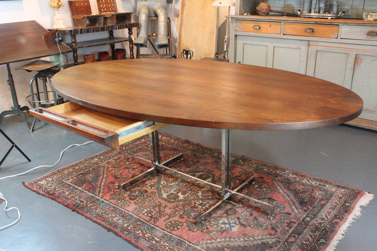 Great modernist form on this Minimalist desk. Drawer is concealed under the walnut top. Could easily be removed if you prefer to use as a dining table.
Great walnut graining and architectural chromed steel base.