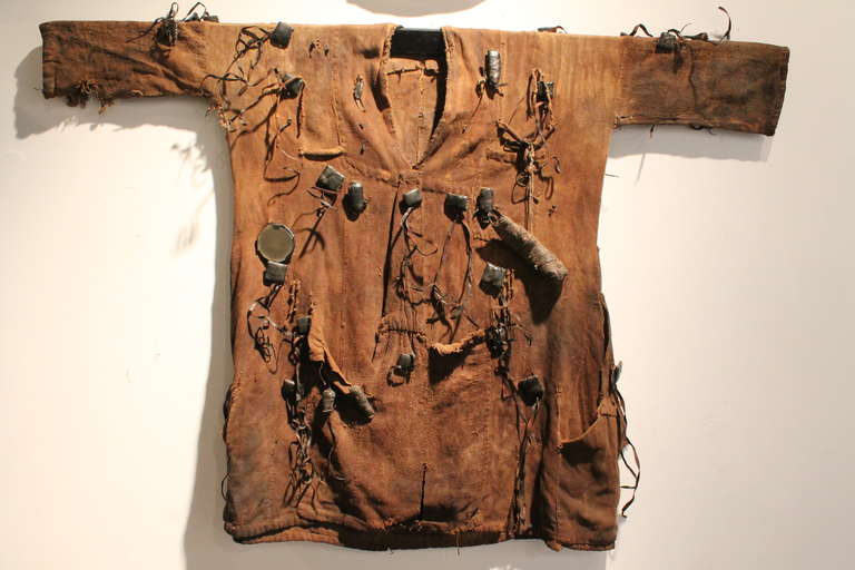 These tunics were worn by Dogon men for protection in the forest during their hunt. They believed that the tunics that were embellished with fetish amulets , small objects, animal horns, mirrors, jewelry, and leather pouches would protect them from