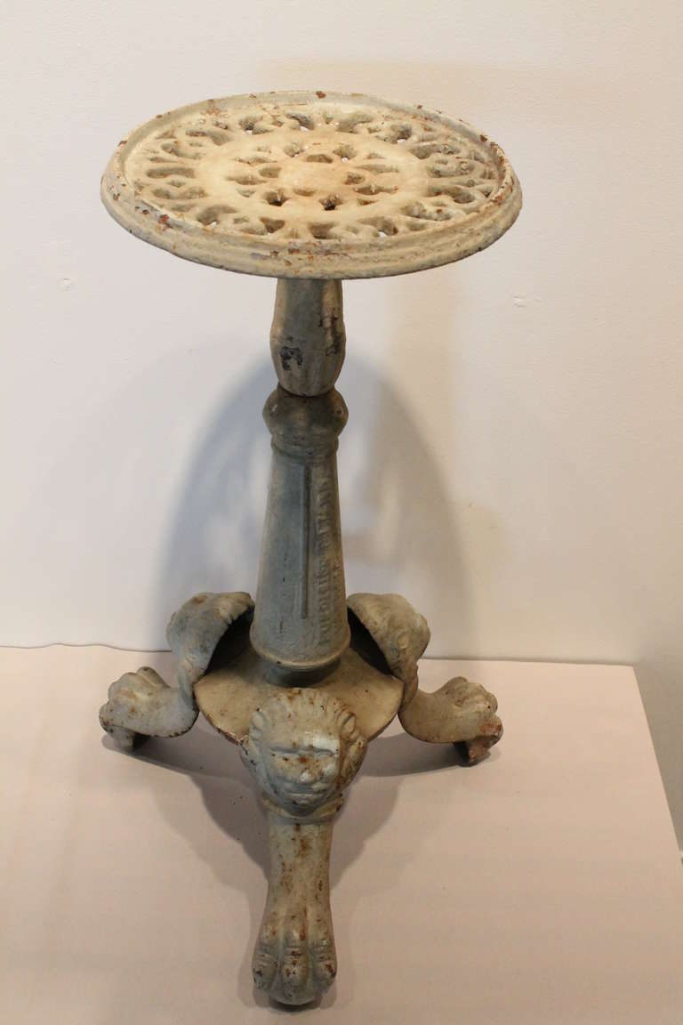 Great original paint and patina on this cast iron swiveling top plant stand from the late 19th Century.
The base has great cast lions heads and ball and claw foot designs. There is a foundry stamp on the column , but we cannot make it out.
Great