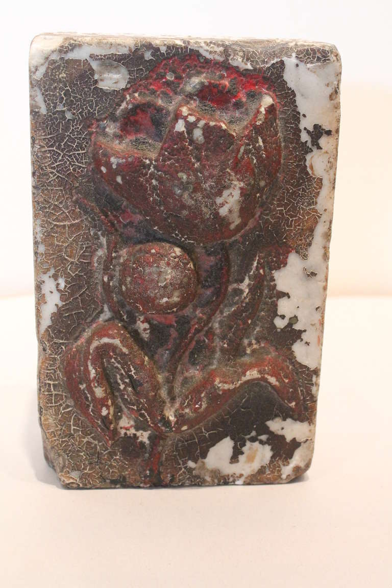 Great paint cracklature and form on this block of marble with a carved and painted tulip.<br />
Architectural fragment or paperweight