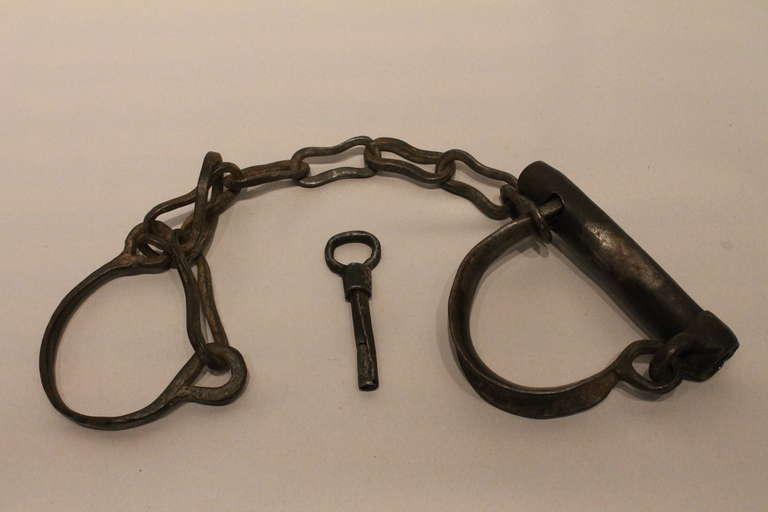 Functioning hand wrought iron 19th century shackles with the original key.<br />
Great patina and wear.