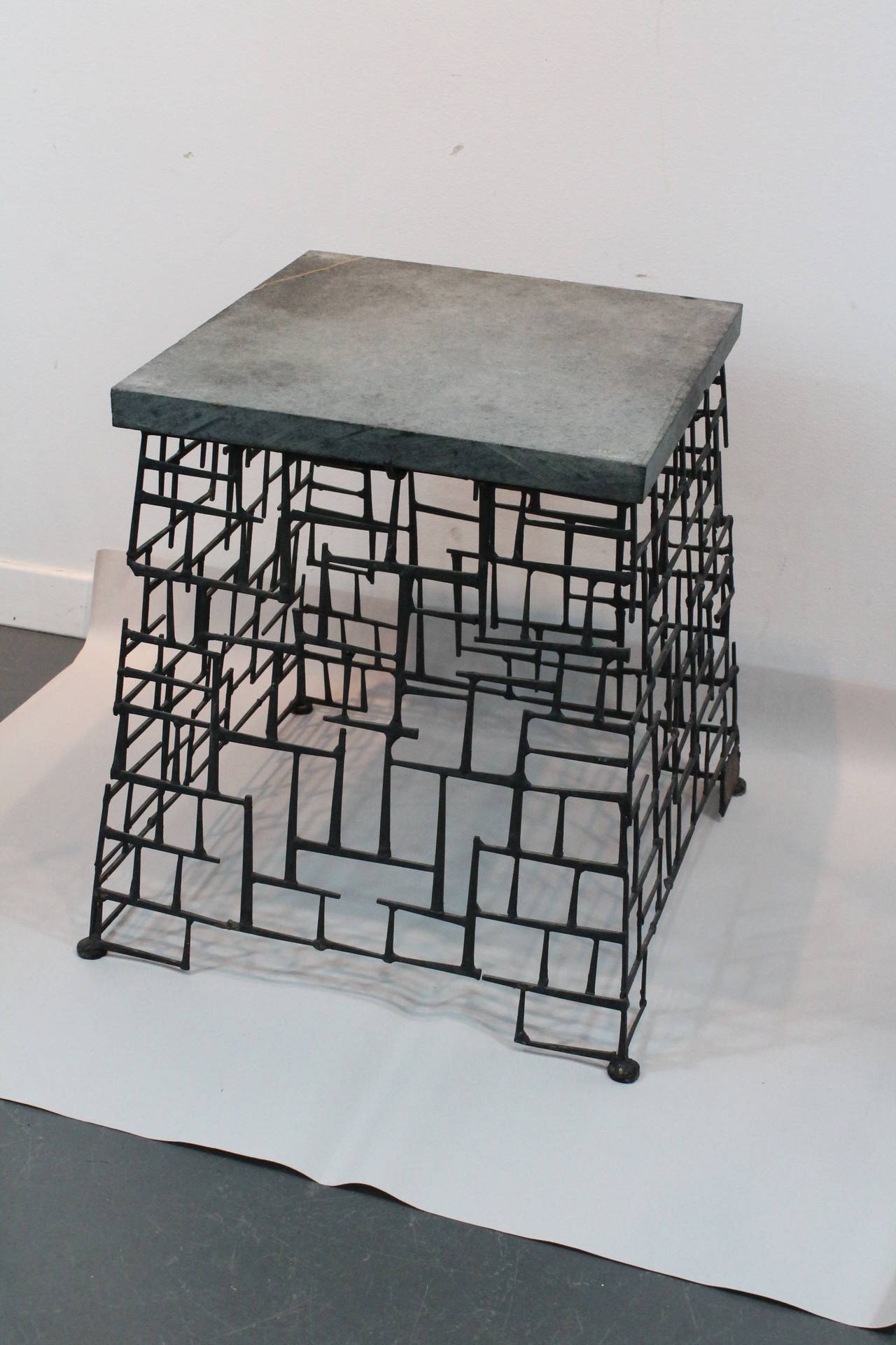Signed Ed Jones 1979 Brutalist nail construction side table with a slate top.
Great modernist form, makes a great sculpture base as well.