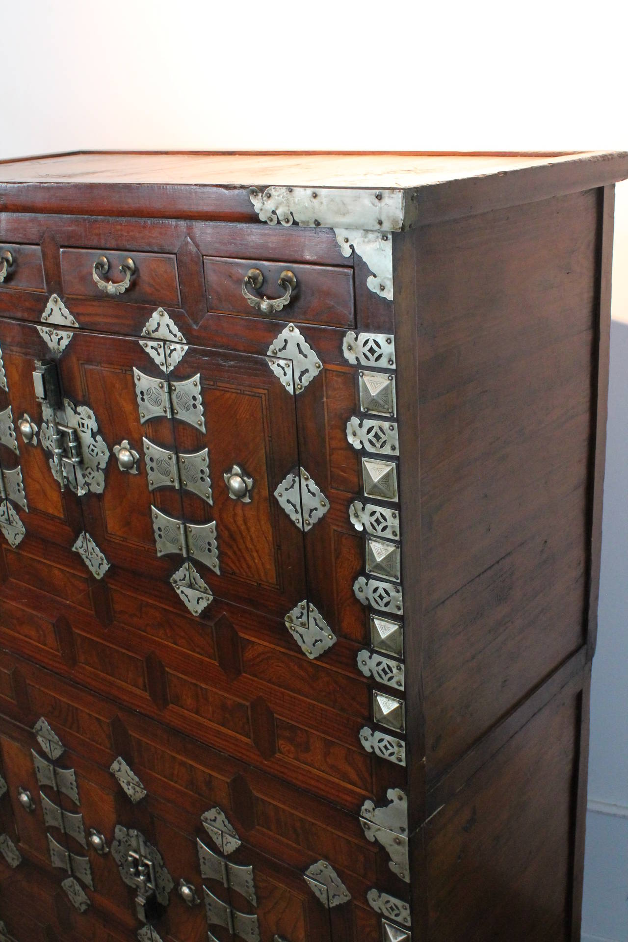 Fantastic silver detailing on this very graphic Korean 19th Century cabinet.
Wonderful luster to the mosaic wood structure.
4 drawers at the top and 2 sets of doors ( one per cabinet ) that open to conceal an inner cavity.
The top doors conceal 2
