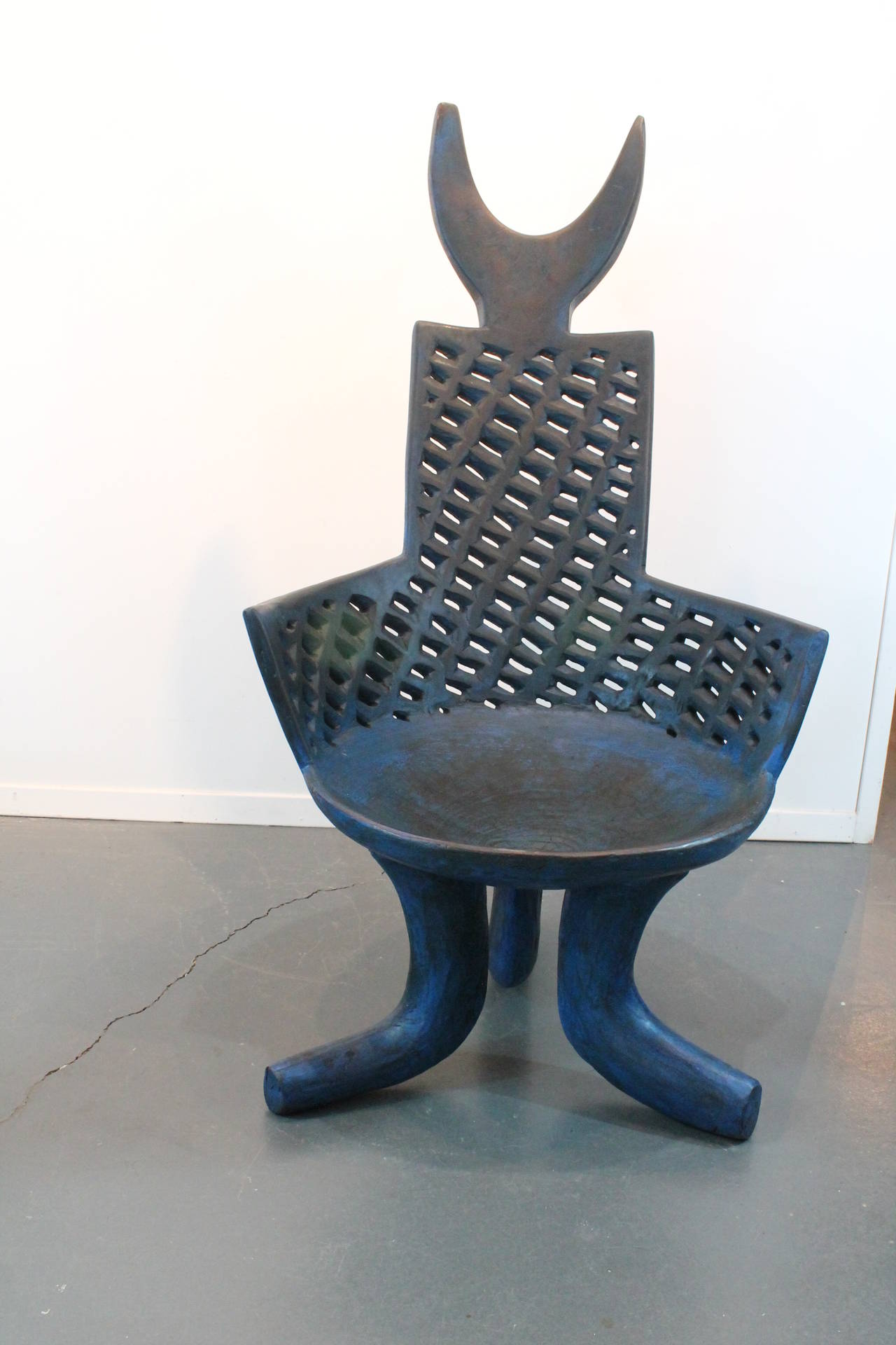 Exceptional and unusual form on these pair of Ethiopian carved armchairs.
The chairs are carved from a single tree and have blue pigment staining.
A sculptural seating exclamation point!!