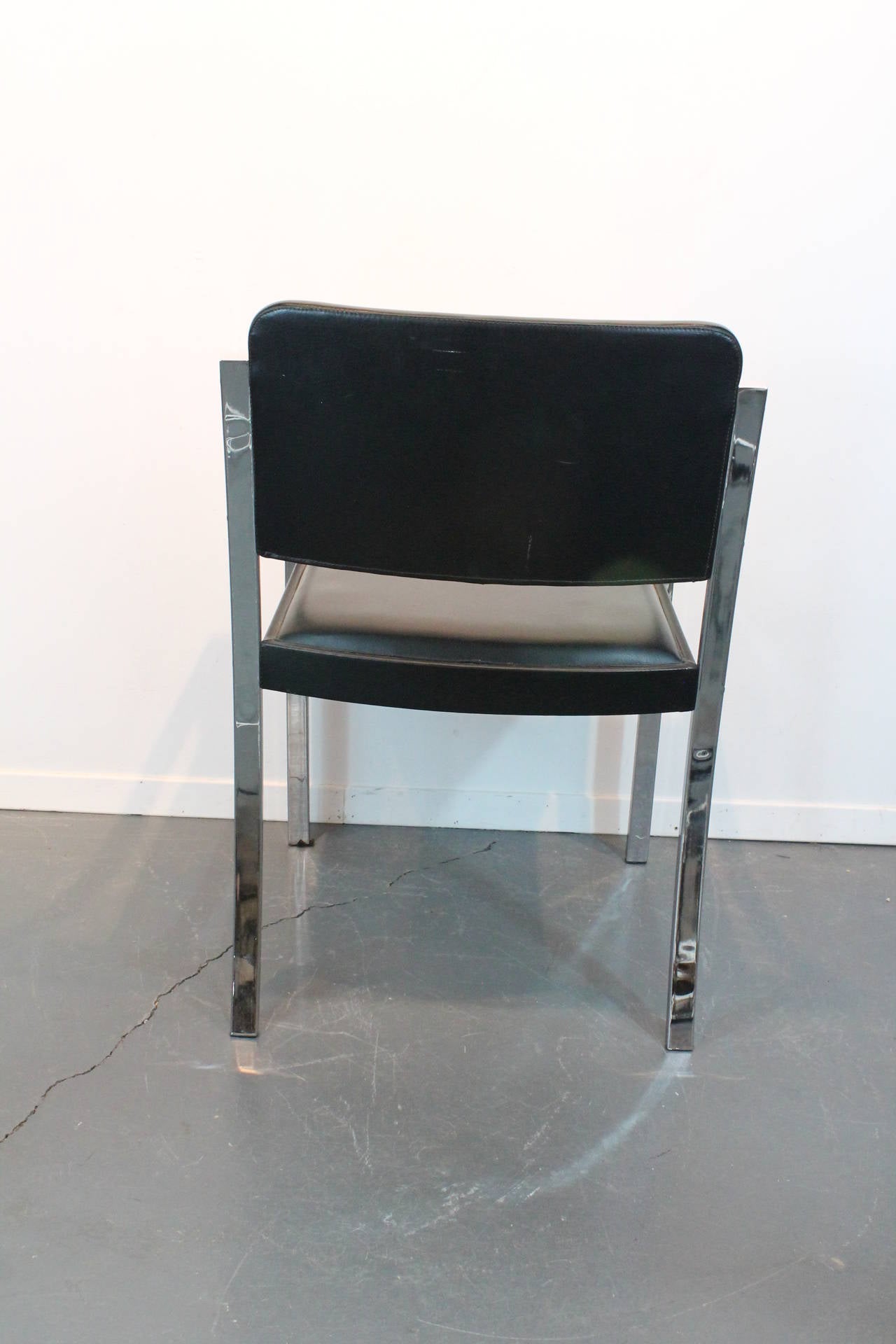 Very clean minimalist designed chrome and black vinyl 1970s dining chairs.