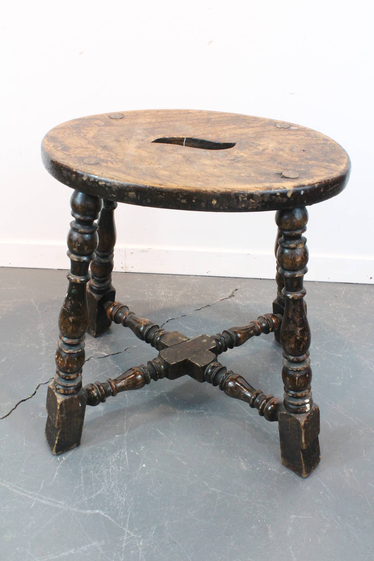 Great design and turnings on this William and Mary stool.
Wonderful stylized cutout in seating surface for carrying.