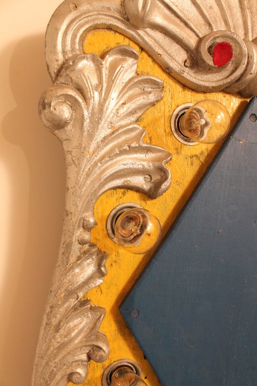 This Colorful and Graphic Carousel Panel is composed of a wooden structure in original paint with a cast aluminum surround. The detailing of the casting includes dragons on the bottom , crawling acanthus leave ornament on the sides and a shell