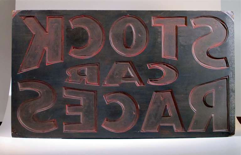Stock Car advertising printer’s block. Strong graphic appeal reflecting the 
typographic style of the 1940’s. Constructed of solid wood showing traces 
of red color from the printing process. Hand craved to advertise local dirt
track racing in
