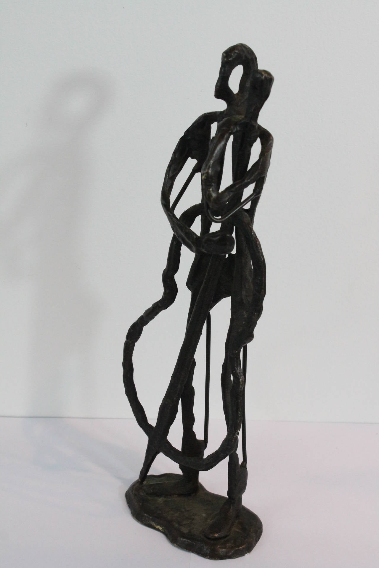 Wonderful evocative Modernist Giacometti-esque bronze sculpture of a bassist.
There are threaded screw taps at the bottom of the sculpture , so the sculpture was originally attached to some sort of base or plinth.