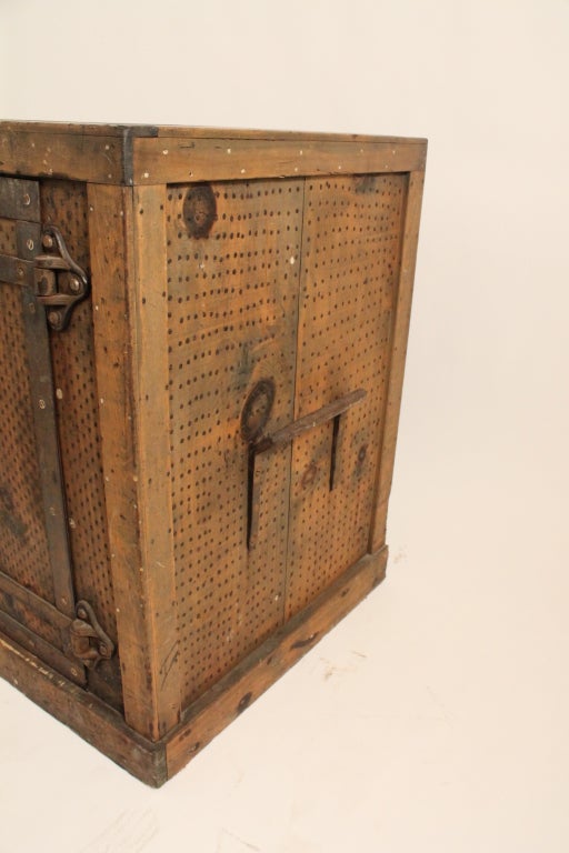 This safe , complete with the key , is an incredibly graphic and unique piece of 19th century furniture.
It is completely surrounded in a grid work of nails , to deter attempts to cut into it. 
It has a very well protected door , surrounded in