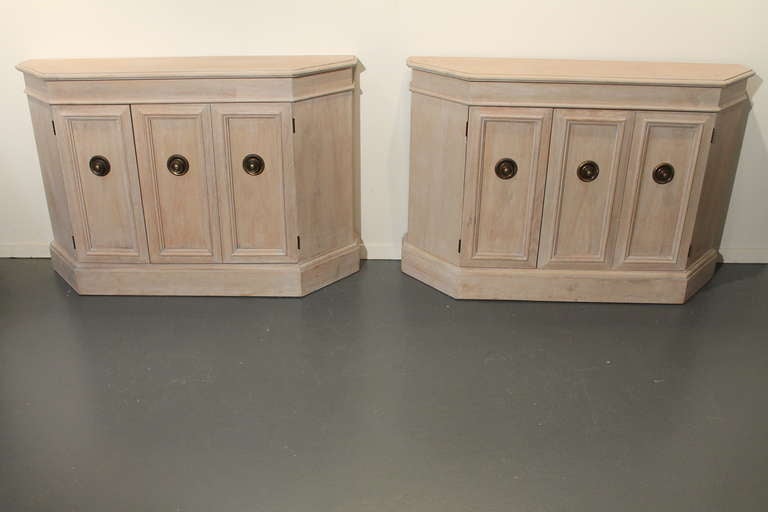Pair of restored 1970's limed cabinets with brass pulls.