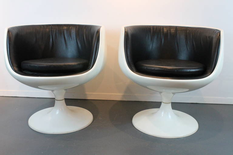 Pair of cast acrylic and black leather Cognac chairs designed by Finnish designer Eero Aarnio.
Aarnio is known for his sleek and innovative furnishings. Aarnio gained recognition in the 1960s with plastic and fiberglass chairs in his now famous