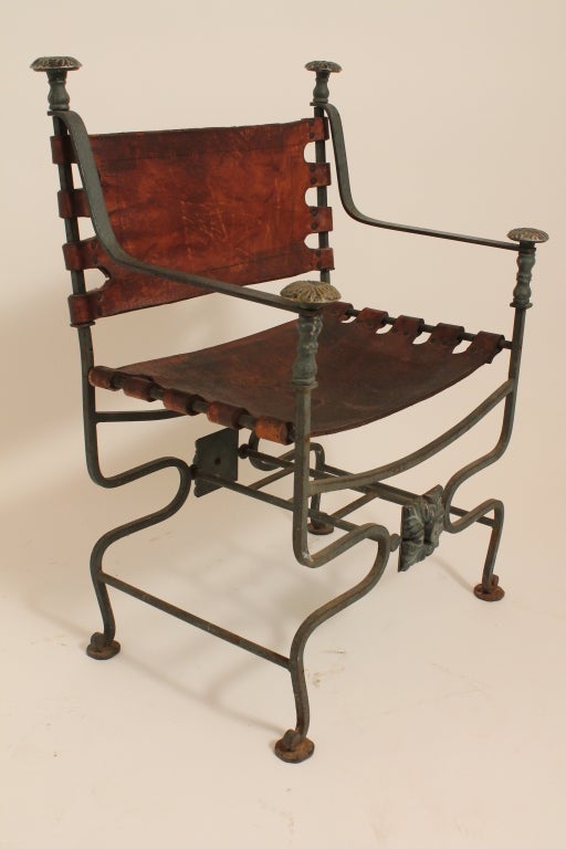 Fantastic designed leather and iron Directoire style chair with great patina and surface.
Detailed bronze finials and floral plates on base of chair.