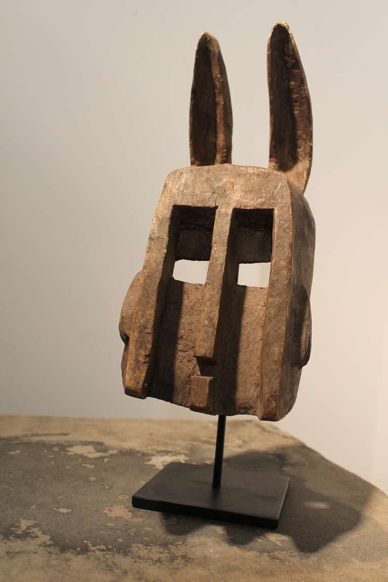 Excellent form on this simple yet very striking geometric dyommo mask (rabbit). It was worn in a ritual story telling dance with the dannana mask (hunter). The hunter pretends to hunt the several rabbit masks performing with him , as they flee in