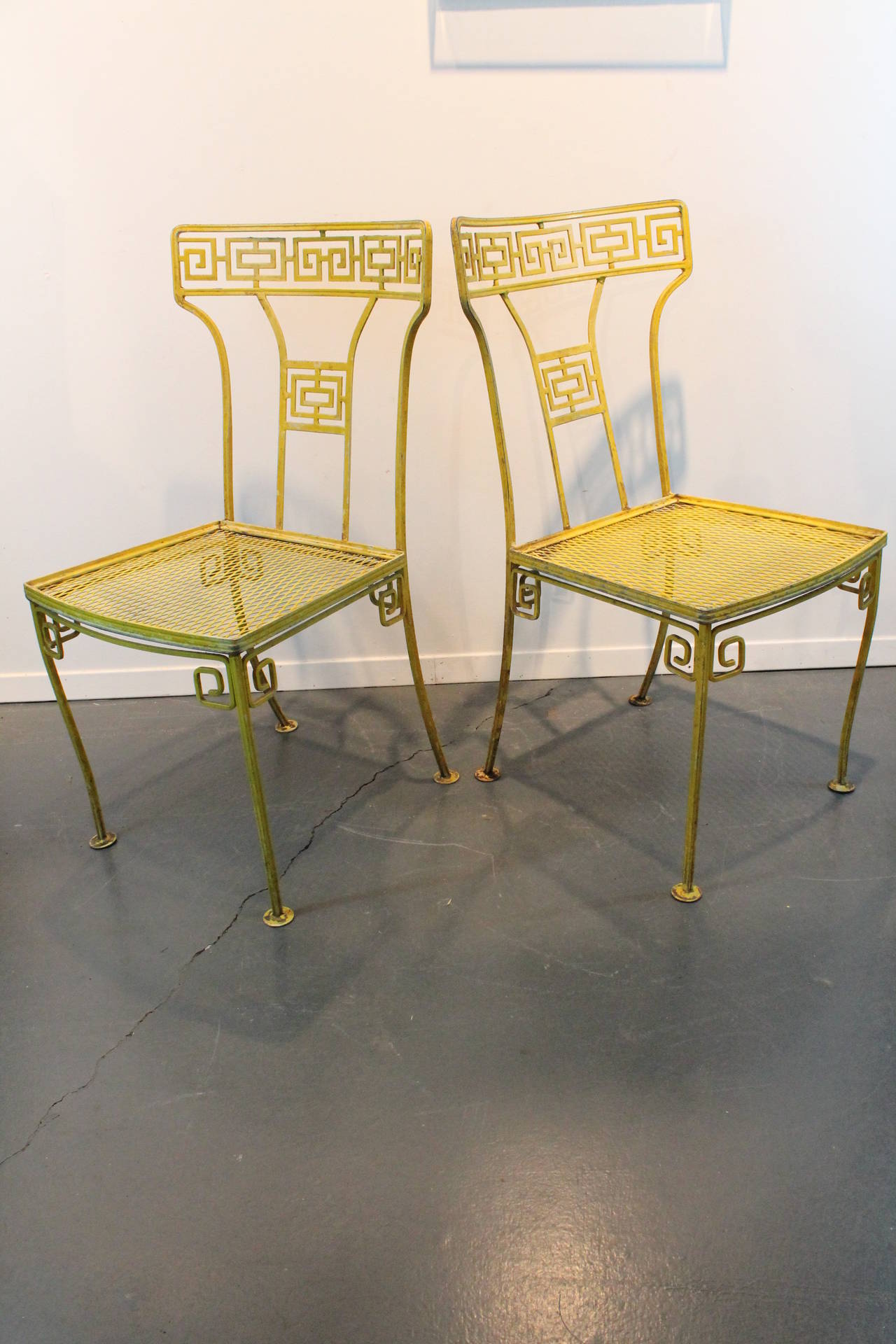 Pair of fantastic Hollywood Regency iron greek key designed garden chairs.
Taken directly out of the garden , in original yellow. Can be sandblasted and powder coated in any color if you prefer.
There is a third chair available.
Attributed to