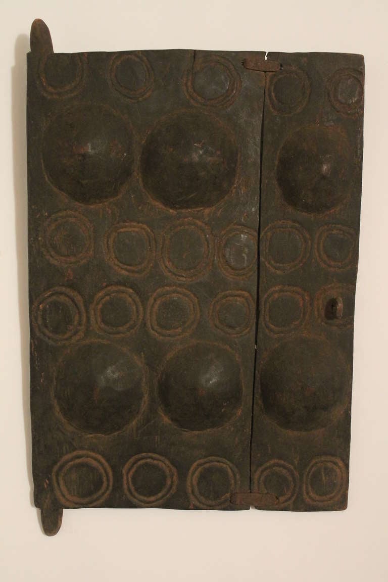 Wonderfully graphic small protective door from the Dogon.  Breast forms are an important fertility and protective symbol.