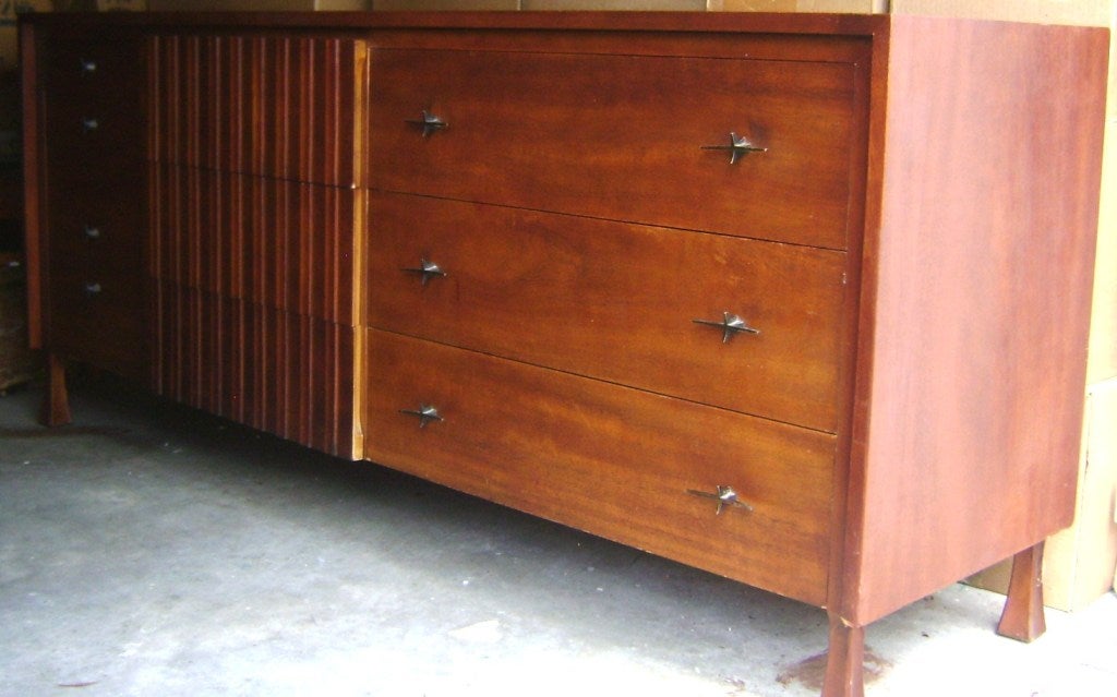 John Widdicomb large commode/dresser in extremely elegant design, enhanced with star- like bronze handles and elevated feet, with lots of compartment space- 10 large and small drawers.Original stamp and numbers.Beautiful and functional.Possibly