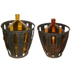 Pair of large antique  amber glass vine bottles w baskets