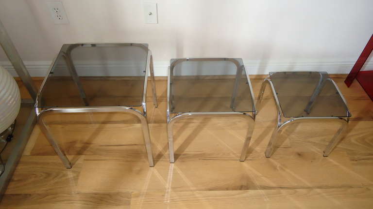 Mid-Century Modern Stack of 3 Chrome Nesting Tableswith dark glass tops.