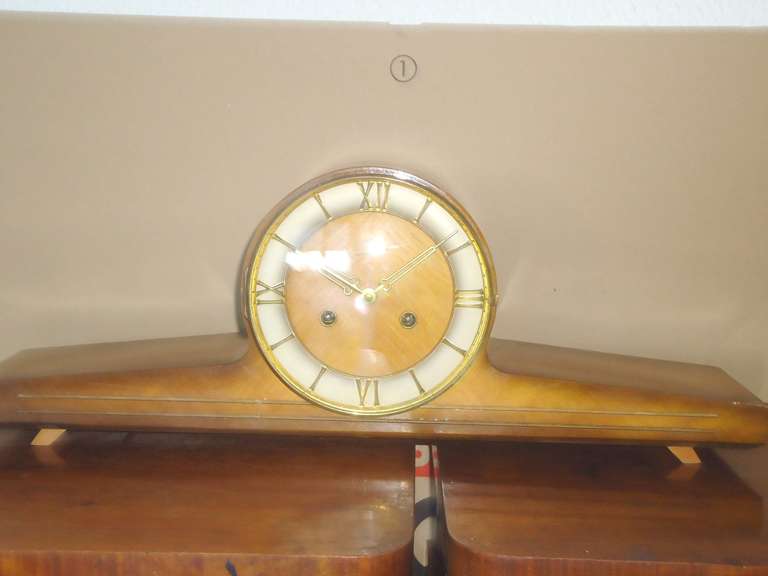Elegant German Mid-Century Modern mechanical mantel clock with roman numerals and very pleasant chimes, striking each half hour.
