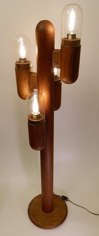 Mid Century carved wood studio floor lamp with original glass globes. Manufacturer's sticker on bottom of base.
