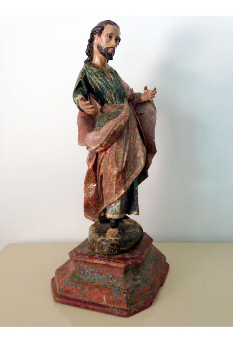 A very fine carved and polychromed wood santos from Latin American of the Spanish Colonial era, circa 19th century. This figure likely depicts John the Baptist in a standing position with arms outstretched that formerly held attributes or an infant.