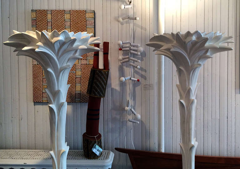 A set of three stunning floor lamps by Sirmos circa 1970s. Made from white plaster after the designs by famed French decorator Serge Roche, these tall and regal floor lamps exude a tropical splendor with a twist of Baroque flare, which originally