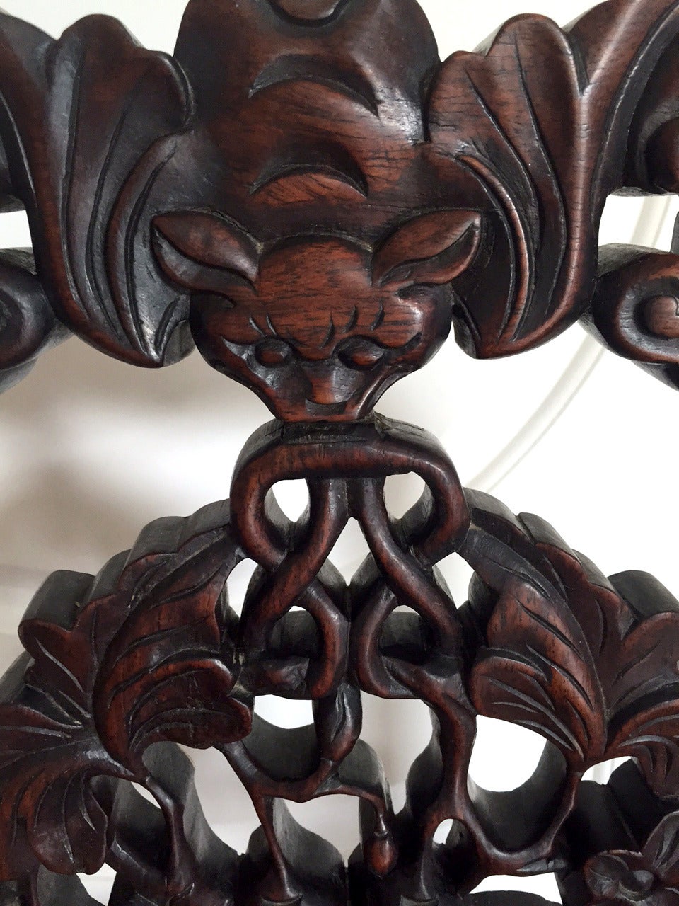 A pair of antique side Chinese side chairs circa 19th century. Made from highly grained HongMu, a hard wood that resembles the Chinese rosewood, Huanghuali. These chairs feature a craved back support with longevity symbols such as bats, fungi and