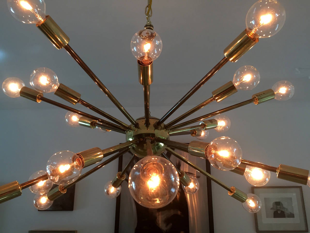 Featuring 24 arms on two tier, this brass sputnik chandelier shows off a lot of vintage charm. American origin likely made by Lightolier circa 1950s', the chandelier displays wonderful patina that comes with age as shown in the last photos. The