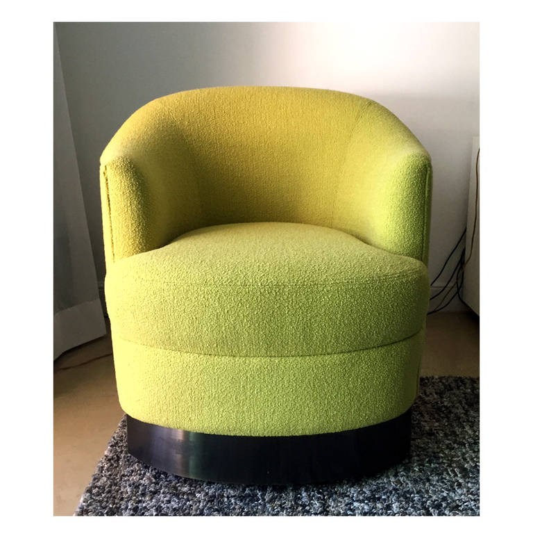 A great looking and practical club or lounge chair by Karl Springer. Newly upholstered in classic Boucle fabric by Knoll with a pewter-finish chrome band around the base. On hidden casters and can be easily moved around. Great looking versatile