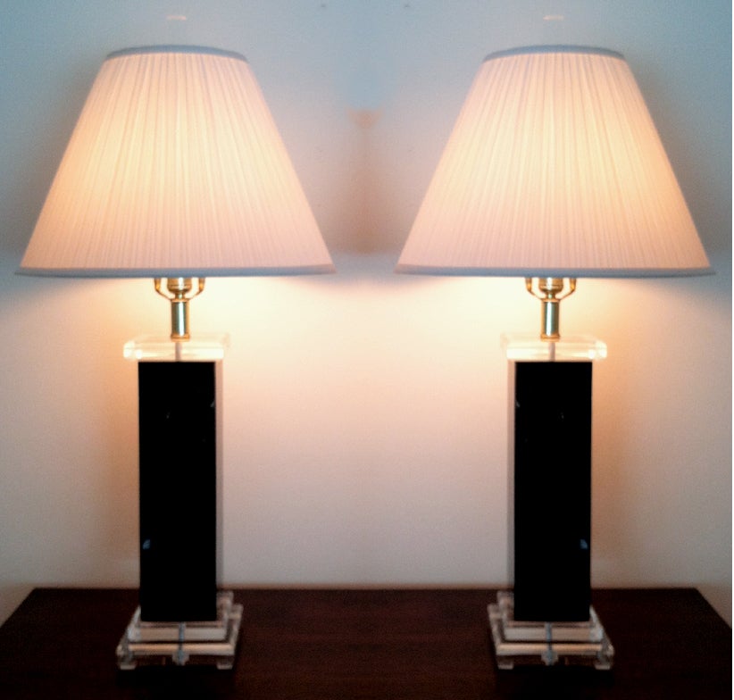 A pair of Lucite table lamps by Bauer Clearlite. It features square stepped base of clear Lucite and black marbleized column. Simple geometrical form and great contrast of colors. Similar to the style by Karl Springer.
