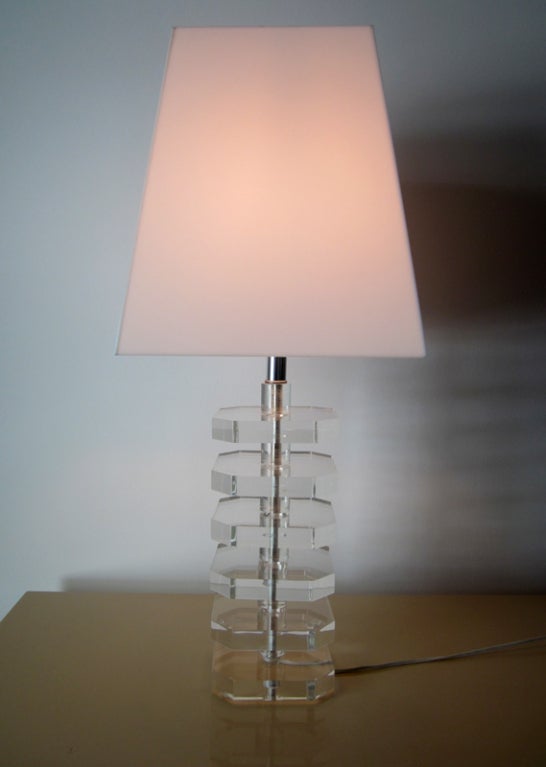 A pair of great looking table lamps circa 1970s, attributed to Karl Springer. The heavy bases feature a stack of lucite disc on steel central rod. The shades are not fabric but opaque acrylic, adding a bit more elegance and ambiance to the vintage