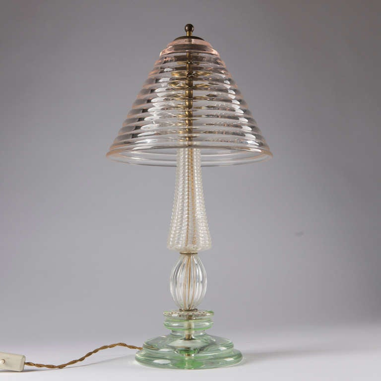 Beautiful tall Murano glass table lamp with brass details.  The piece appears like  a sample collection of different glass techniques: every element of the base and shade has been made with a different technique.
