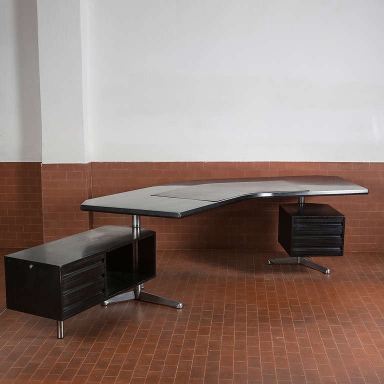Beautiful desk model T69 by Osvaldo Borsani for Tecno.
Two revolving chests of drawers, boomerang shaped leather top.
Also available from the same design 3 cupboards with aluminium top and one metal bin (not swown on pictures).