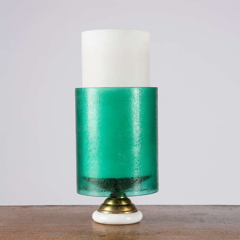 Beautiful Fifties table lamp.
Two different glass cilindric shades give a soft light, marble foot and brass details.
Colours and shapes remember the work of Stilnovo.