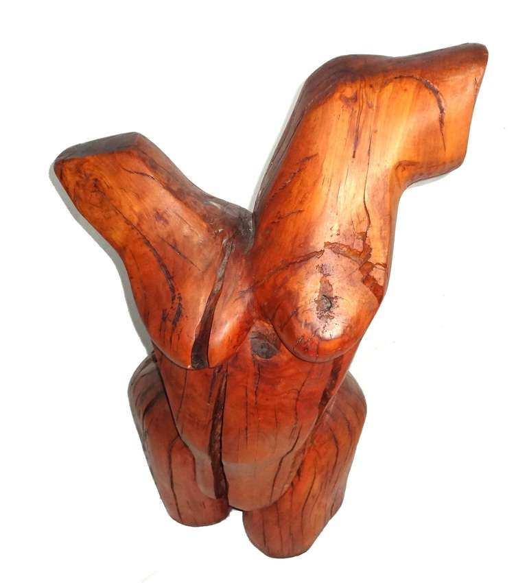 Carved cherry female torso sculpture.