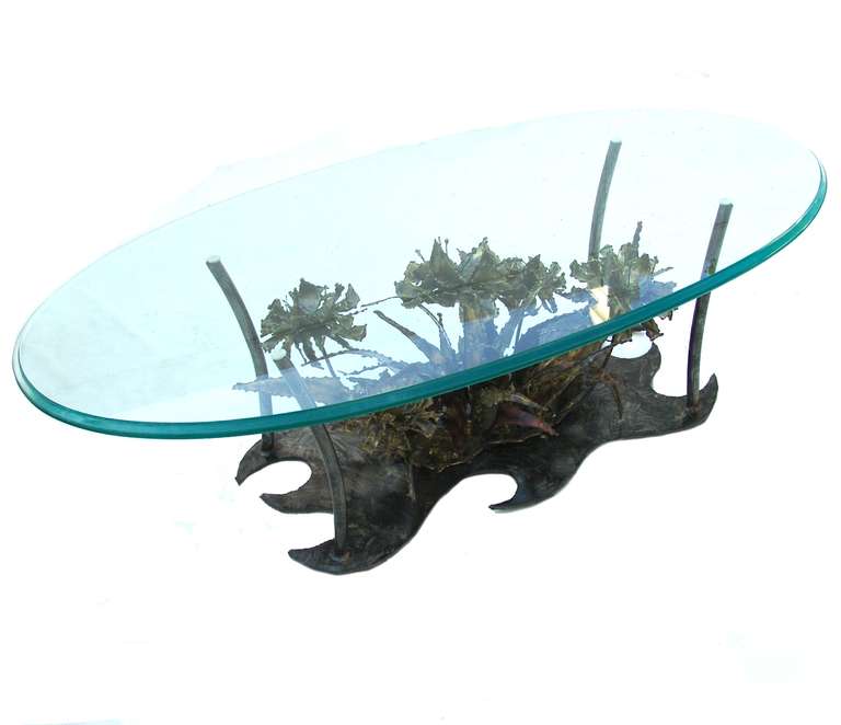 Silas Seandel floral Brutalist coffee table with beveled oval glass top. The base alone measures 34