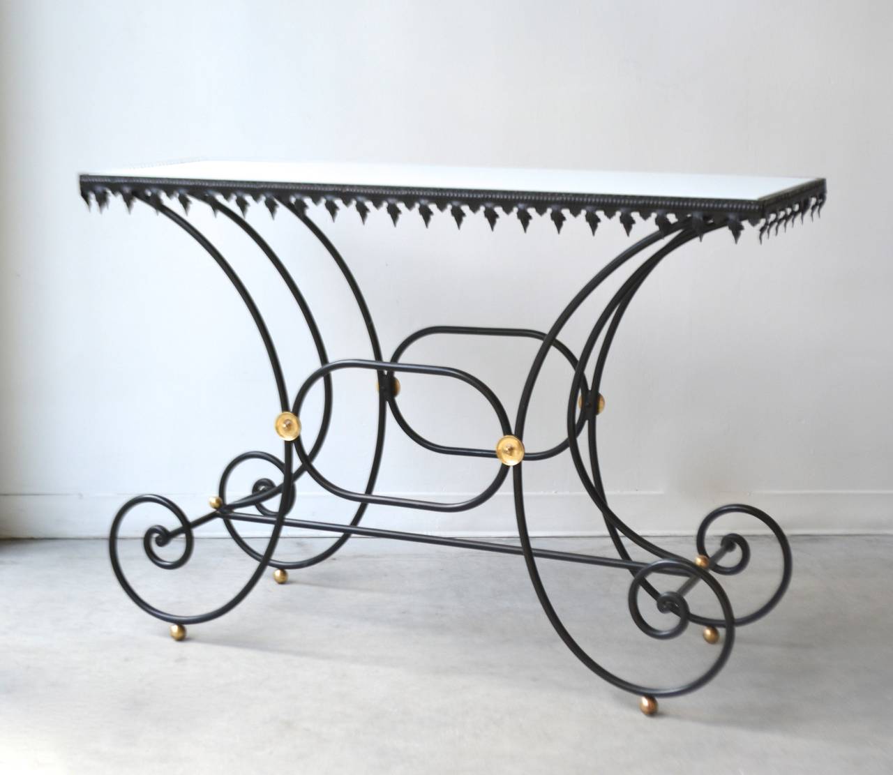 Stunning Hollywood Regency style wrought iron and white milk glass French Baker's Table, c. 1950s. Highlighted with metal embellishments and brass accents.
Overall dimensions:
34.5