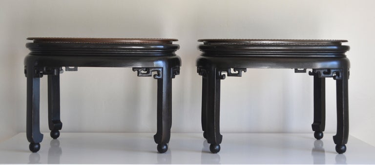 Pair of exquisite Hollywood Regency style black lacquered tray coffee tables. This pair of Chinoiserie inspired coffee tables with removable patinated brass trays create a stylish decorative look with or without the trays, c. 1960s -1970s.