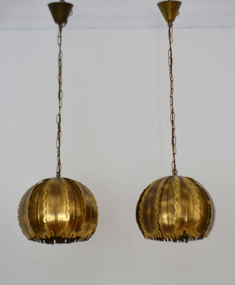 Incredible pair of Danish Brutalist torch cut brass chandeliers by Holm Sorenson, c. 1960s -1970s This stunning pair of brass pendant lights have been rewired and are in their original patina. The forms are 10