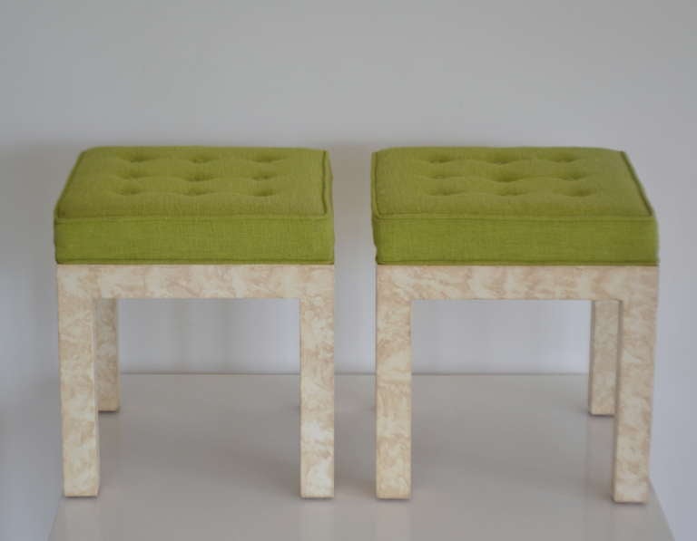 Stunning pair of Mid Century Modern Parsons style benches, c. 1960s - 1970s. These exquisite button tufted stools are upholstered in a green linen fabric and mounted on faux painted bases.