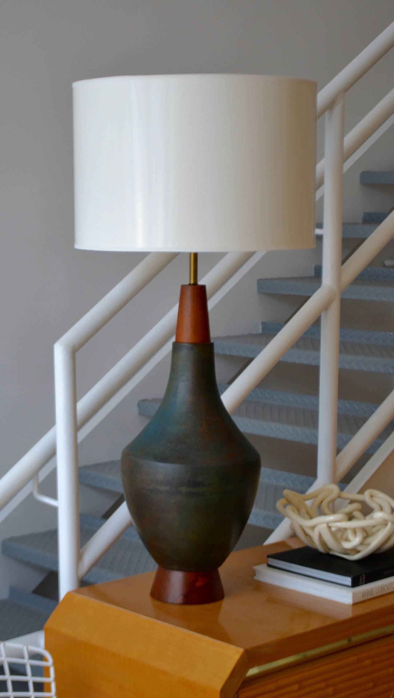 Mid Century Modern ceramic table lamp, c. 1950s - 1960s. Stunning craftsmanship with deep variegated glazing of green, umber, grey and black. The teak base and cap have been artistically turned and honed.
Shade not included. 

Overall
