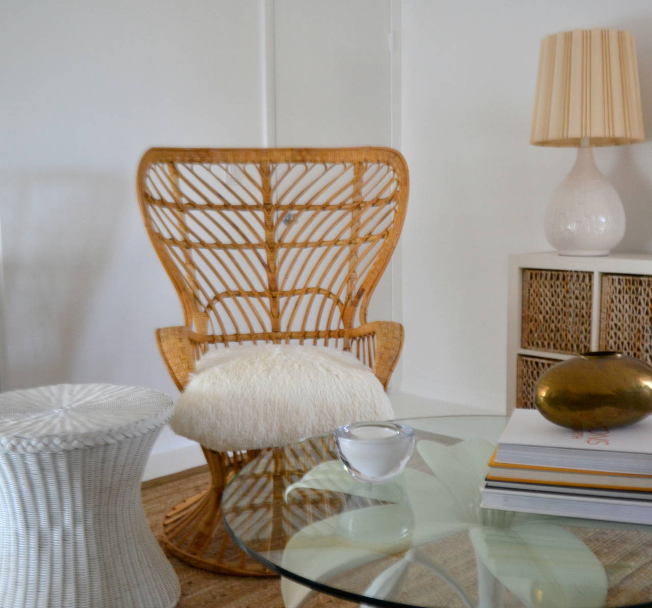 Striking Mid Century Modern woven rattan and bamboo peacock occasional chair,  c. 1950s -1960s. This stunning sculptural wicker side chair by Lio Carminati and Gio Ponti is designed and accented with a shag pile upholstered down cushion.