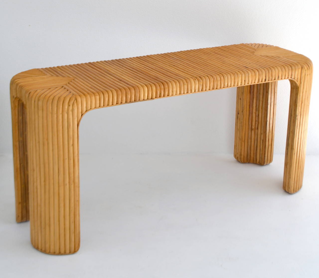 Incredible Mid Century Modern split rattan console / sofa table in the style of Paul Frankl, c. 1970s.