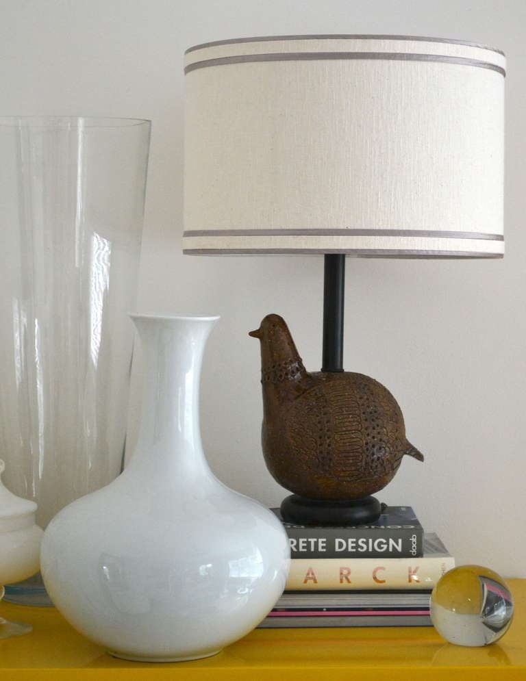 Mid-Century Modern partridge form ceramic table lamp designed by Aldo Londi for Bitossi, c. 1960. This Italian lamp is a beautiful combination of umber glaze and matte stoneware embossed with whimsical and graphic design elements, mounted on an