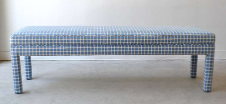Incredible Mid Century Modern upholstered Parsons style bench in the style of Milo Baughman, c. 1960s - 1970s.  This striking bench is upholstered in a blue and white textured cotton fabric.