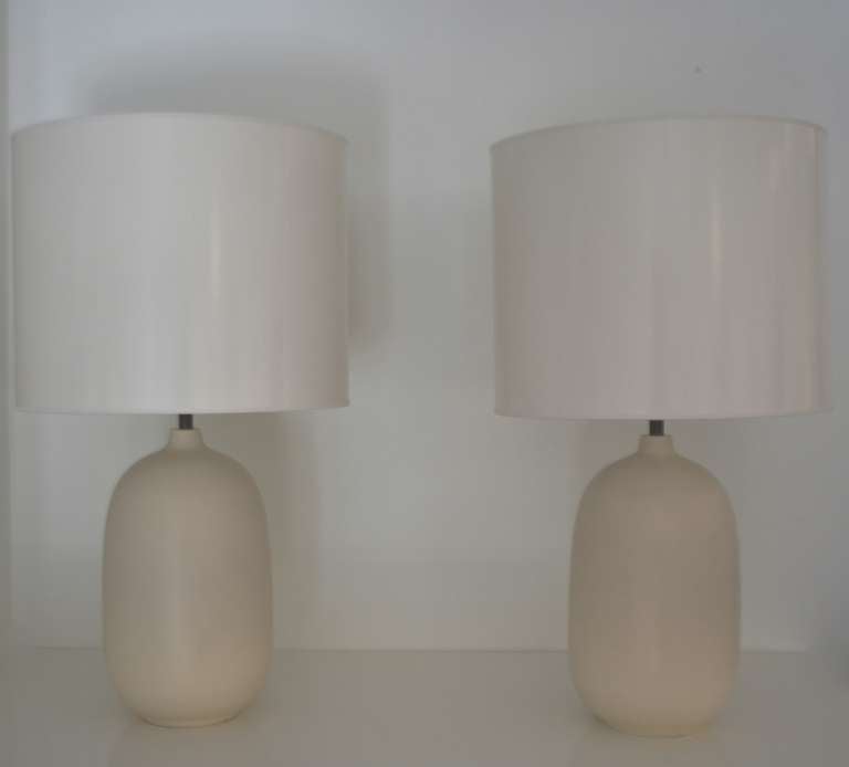 Incredible pair of white glazed ovoid form table lamps, circa 1970s.<br />
This stunning pair of egg shell matte glazed lamps are in excellent original condition. Sold without shades<br />
Measurements:<br />
Form Height from the base to the bottom