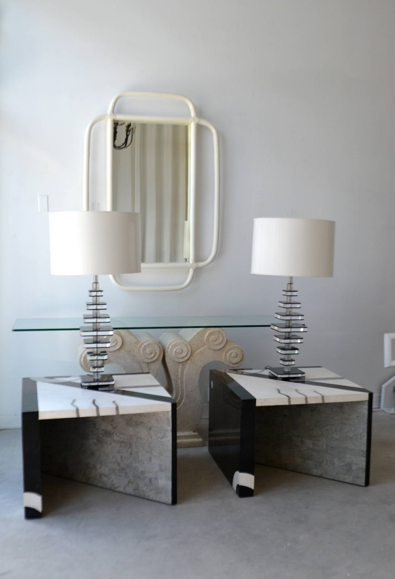 Pair of Postmodern sculptural geometric side tables in tessellated stone with chrome inlays by Oggetti, circa 1980s. These stunning end tables are designed of contrasting tessellated marble in graphic patterns creating a striking Silhouette.
